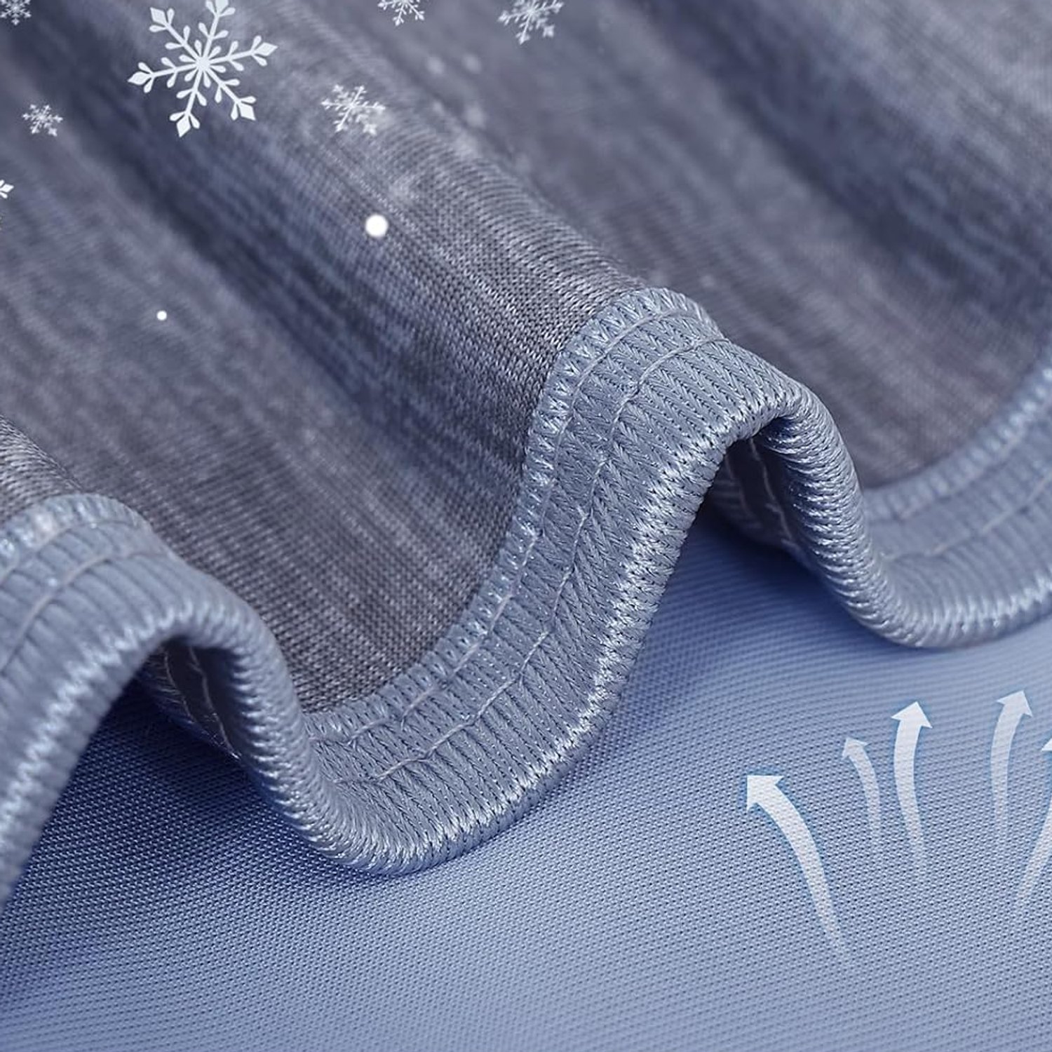 Close-up of the Lavender Grey blanket's two faces: the cooling knit folded back over the paler breathable reverse
